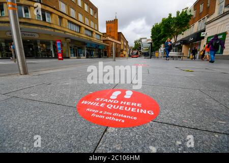 Exeter, Devon, UK.  13th June 2020.   Shops selling unessential items to reopen on Monday at Exeter in Devon as lockdown restrictions are eased further during the coronavirus pandemic.  Social distancing markers on the ground on the high street.  Picture Credit: Graham Hunt/Alamy Live News Stock Photo