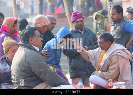 Hindu priest performing religious rituals at Ganges river bank in Varanasi, India. One of the oldest city in the world & important pilgrimage site for Stock Photo