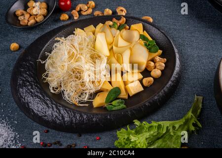 Cheese Plate with Grapes, Nuts and Honey Stock Photo
