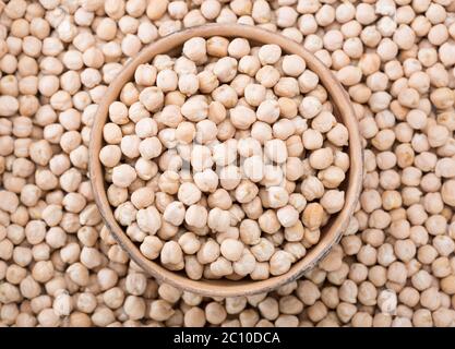 Old clay bowl with dried chickpeas.Top view. Selective focus. Stock Photo