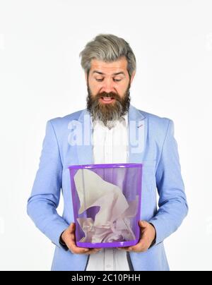Office worker digging in garbage bin. Recover document. Destroy evidence. Rummaging in trash. Recover files after deletion. Businessman hold trash can. Man look for lost document in paper bin. Stock Photo