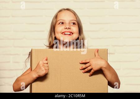 Rent house. Real estate. Make moving easier. Girl small child carry cardboard box. Packaging things. Move out concept. Delivering your purchase. Kid moving out. Moving routine. Prepare for moving. Stock Photo