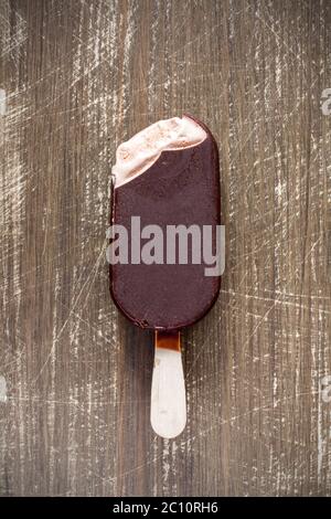 Bitten chocolate covered vanilla ice cream bar Stock Photo