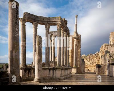 The ancient Roman archeological site of Dougga (Thugga), Tunisia, with dramatic columns at the entrance to the well preserved amphitheatre Stock Photo