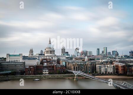 Dome of St. Pauls Cathedral and modern skyscrapers of The City of London as seen from the South shore of the river Thames on a cloudy Summer day. Long Stock Photo