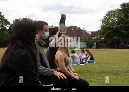 London, UK. 13th June, 2020. Protestors gather in Alexandra Park, Surbiton to take part in a protest in support of the Black Lives Matter movement. Localised protests have sprung up across London this weekend due to fears of violence from far-right groups in central London. Credit: Liam Asman/Alamy Live News Stock Photo