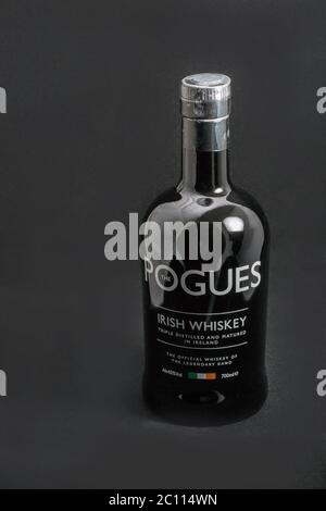 KIEV, UKRAINE - MAY 15, 2019: The Pogues blended Irish Whiskey triple distilled and matured bottle closeup against black background. It is the officia Stock Photo