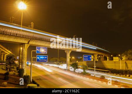 Long exposure image of Delhi Metro passing over the main ring road in New Delhi, India Stock Photo