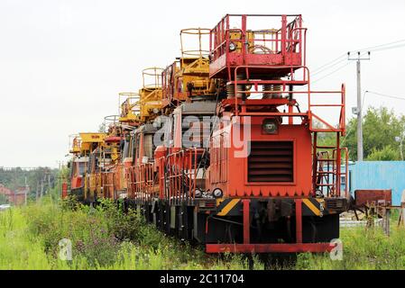 Railway heavy duty machines train entering the station Stock Photo