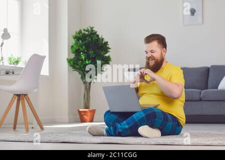Funny bearded man talking to his girlfriend or lover online. Romantic guy maintaining long distance relationship on web Stock Photo