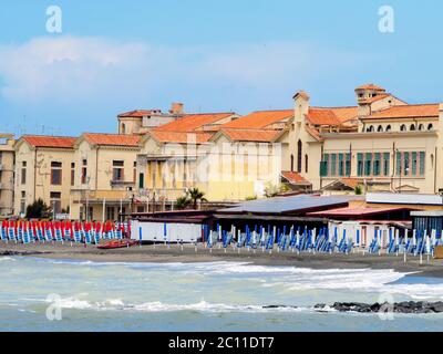 Beach Umbrella in fron of the Vittorio Emanuele an early 20th century building in Ostia Lido - Rome, Italy Stock Photo