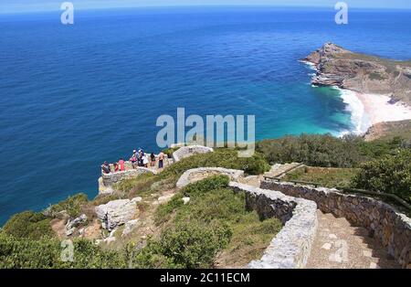 The Cape of Good Hope with Dias beach, seen from the cliffs above Cape Point. Tourists on a viewing platform. South Africa, Africa. Stock Photo