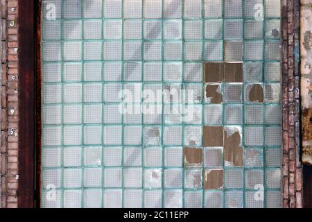 Texture of blue glass bricks with broken elements. Stock Photo