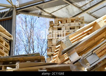 Waste wood from pallets stacked in the storage room Stock Photo