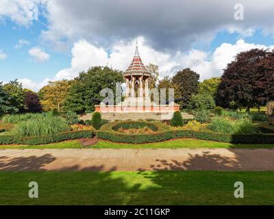 Dark clouds gather over the old Chinese Bell Tower building in the gardens of the Nottingham Arboretum Stock Photo