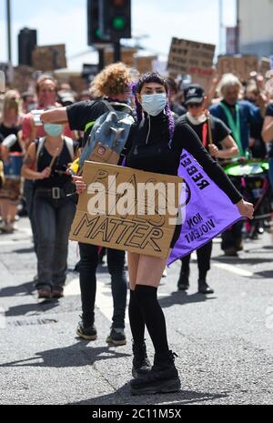 Brighton UK 13th June 2020 - Thousands take part in the Black Lives Matter anti racism protest rally through Brighton today . There have been protests throughout America , Britain and other countries since the death of George Floyd while being arrested by police in Minneapolis on May 25th : Credit Simon Dack / Alamy Live News Stock Photo