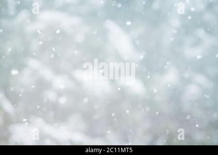 Snow falling and floating on the air, wintry xmas abstract background Stock Photo