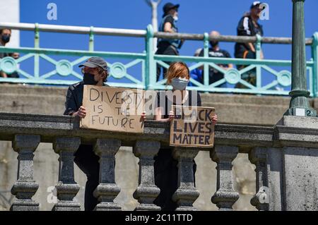 Brighton UK 13th June 2020 - Thousands take part in the Black Lives Matter anti racism protest rally through Brighton today . There have been protests throughout America , Britain and other countries since the death of George Floyd while being arrested by police in Minneapolis on May 25th : Credit Simon Dack / Alamy Live News Stock Photo