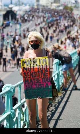 Brighton UK 13th June 2020 - Thousands take part in the Black Lives Matter anti racism protest rally through Brighton today . There have been protests throughout America , Britain and other countries since the death of George Floyd while being arrested by police in Minneapolis on May 25th : Credit Simon Dack / Alamy Live News Stock Photo