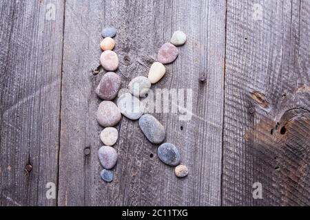 X - Letter alphabet stones laid out on the old wood Stock Photo - Alamy