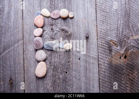 X - Letter alphabet stones laid out on the old wood Stock Photo - Alamy