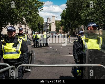 London, UK. 13th June, 2020. Police form a line during the protest. Hundreds of members of far-right nationalist groups, including the English Defence League (EDL) gather to protest against the removal and damage to monuments and statues that were targeted by Black Lives Matter protestors due to their links to racism and the slave trade. Credit: Yousef Al Nasser/ Alamy Live News Stock Photo