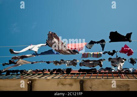 beautiful clothes hanging to dry on the balcony Stock Photo