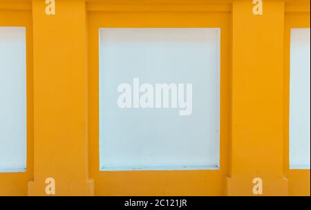 Street image of bright yellow and white wall. Selective focus. Stock Photo