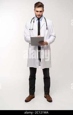 Full length young medical doctor on white background. Stock Photo