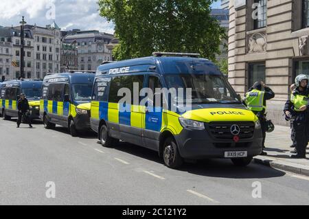 Police vans full of police in full protection gear getting ready to go into a far right protest in Trafalgar Square. London Stock Photo