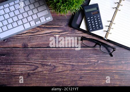 high angle view of calculator, notepad and keyboard with copy space  Stock Photo