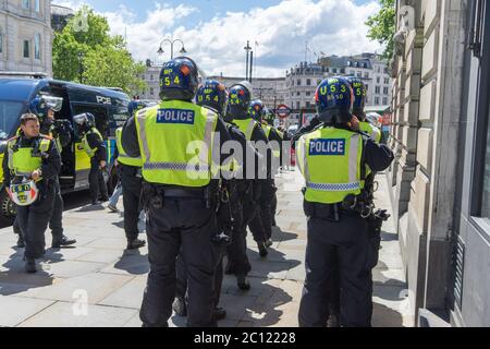 Riot police in full protection gear getting ready to go into a far right protest in Trafalgar Square. London Stock Photo
