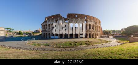 Panorama of the Colosseum amphitheater from the southern ridge, at sunrise, in Rome, Italy, showing stone archs and brick works of the inner rim of th Stock Photo