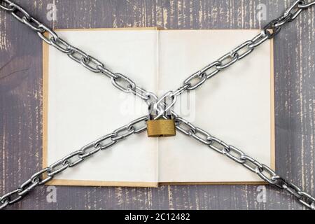 Open book with chain and padlock. Stock Photo
