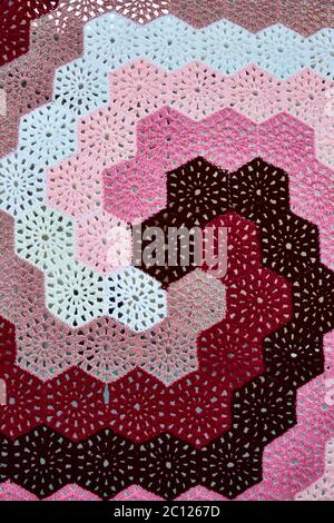 Close up of a colourful spiral traditional hexagonal knitted crochet pattern. Stock Photo
