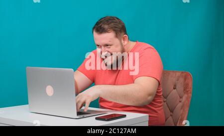 Funny frames of male using laptop. man working on a computer pretending to be a hacker. Stock Photo