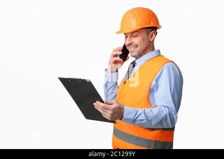 Construction Worker Talking On Phone Holding Folder Over White Background Stock Photo