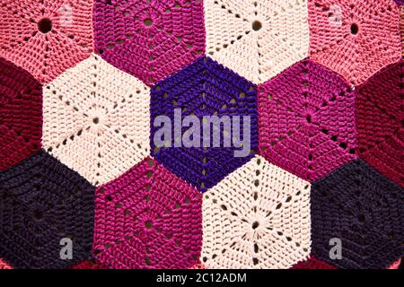 Close up of a colourful traditional hexagonal knitted crochet pattern. Stock Photo