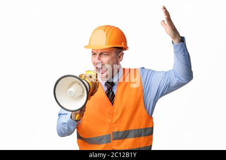 Angry Builder Worker Shouting In Megaphone Standing Over White Background Stock Photo
