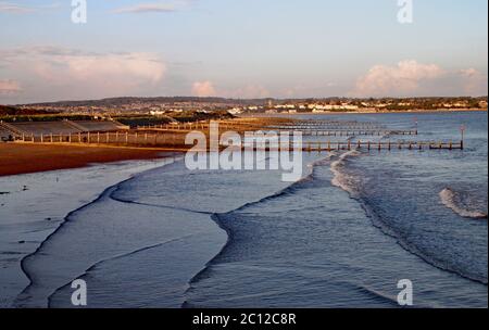 Sun setting on Dawlish Warren with Exmouth in the background Stock Photo