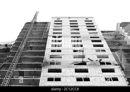 black and white Protective catching grid net belay guard tense in the construction of a multistory newly building house. Stock Photo
