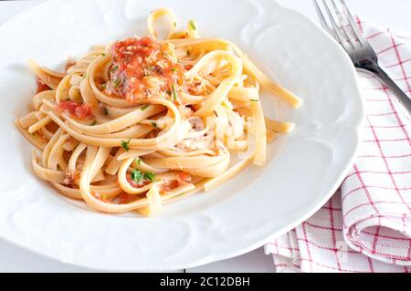 noodles with crab sauce and chopped tomatoes Stock Photo