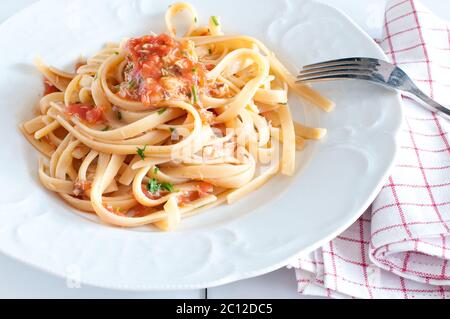 noodles with crab sauce and chopped tomatoes Stock Photo