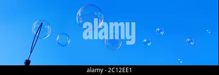 Soap bubbles against blue sky. Stock Photo