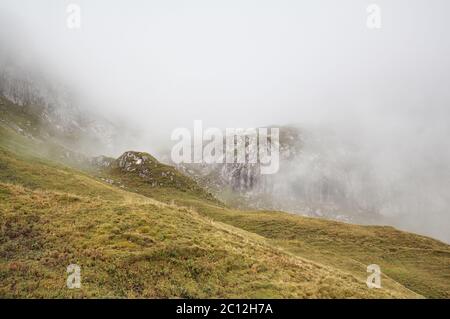 rocky mountains in dense fog Stock Photo