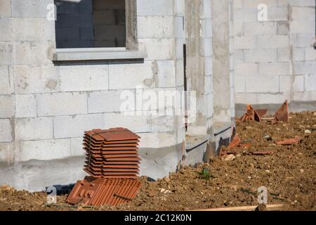 Concrete block wall pattern and roof tiles ready to fasten Stock Photo