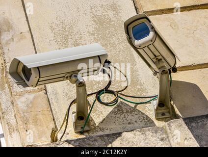 two security CCTV cameras or surveillance system in office building Stock Photo