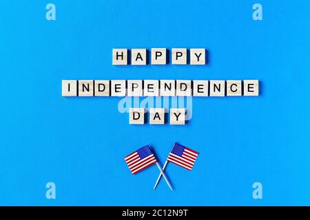 happy Independence Day inscription in wooden letters on a blue background. Happy Independence Day. The 4th of July. USA Independence day. American fla Stock Photo