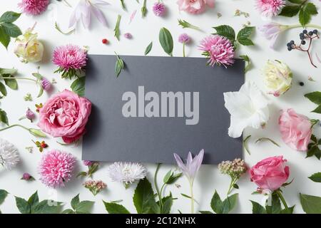 Beautiful pink and white flowers with empty notebook Stock Photo
