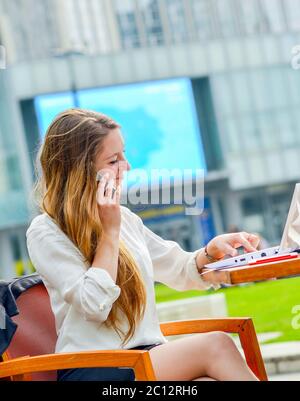 dynamic young executive taking notes on her agenda Stock Photo